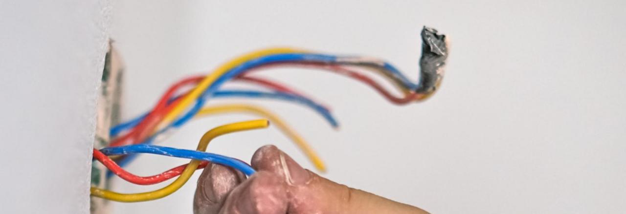 contractor inspecting wiring on home