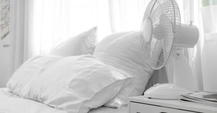 White bedroom with a white fan