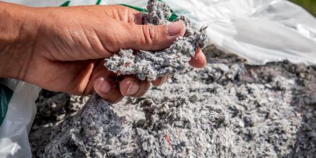hand picking up cellulose insulation