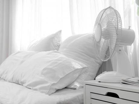 White bedroom with a white fan